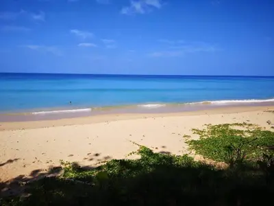 a sandy beach with the ocean in the background at MA MAISON BOUTIQUE HOTEL. in PHUKET in Bang Tao Beach