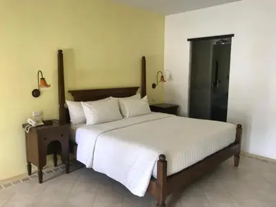 a bedroom with a large bed and a shower at Ao Nang Colors Hotel - Aonang Beach in Ao Nang Beach
