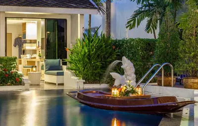 a statue of a bird in a fountain in a yard at Access Resort & Villas - SHA Plus in Karon Beach