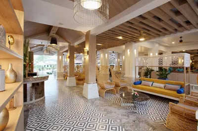 a lobby of a hotel with a couch and chairs at Access Resort & Villas - SHA Plus in Karon Beach