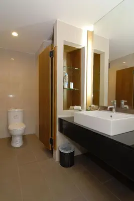 a bathroom with a large sink and a toilet at Peach Blossom Resort & Pool Villa - SHA Plus in Kata Beach