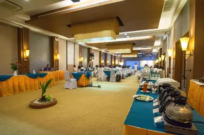 a banquet hall with tables and people in a room at Peach Blossom Resort & Pool Villa - SHA Plus in Kata Beach