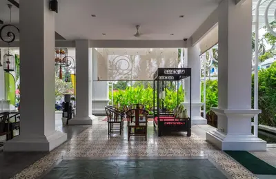 a lobby with chairs and tables in a building at The Old Phuket - Karon Beach Resort in Karon Beach
