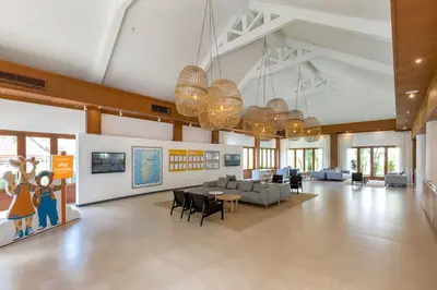 a lobby with a couch and a table and chairs at Sunwing Bangtao Beach in Bang Tao Beach