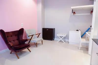 a living room with a chair and a table at The Beach Boutique House in Kata Beach