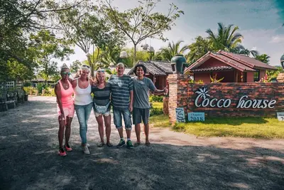 a group of people posing for a picture in front of a coco house at Cocco House in Ao Nang Beach