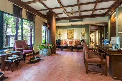 a lobby of a hotel with chairs and a couch at Diamond Cottage Resort & Spa in Karon Beach