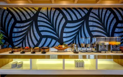a buffet with a blue and white patterned wall at Namaka Resort Kamala in Kamala Beach