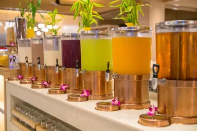 a row of different types of drinks on a counter at Centara Karon Resort Phuket in Karon Beach
