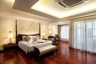 a bedroom with a bed and a desk in a room at Patong Paragon Resort & Spa SHA Extra Plus in Patong Beach