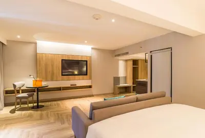 a living room with a couch and a tv at Holiday Inn Resort Krabi Ao Nang Beach by IHG in Ao Nang Beach