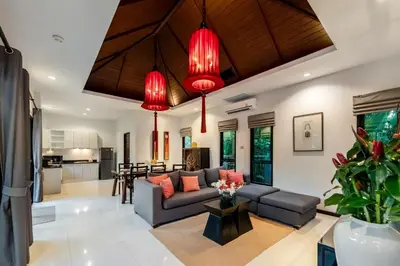 a living room with a couch and red chandeliers at The Bell Pool Villa Resort Phuket in Kamala Beach