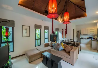 a living room with a couch and a table at The Bell Pool Villa Resort Phuket in Kamala Beach