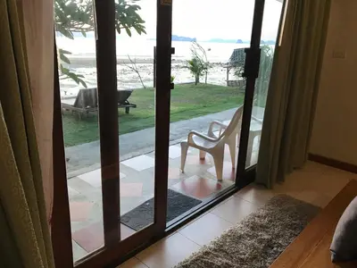 a door leading to a patio with a chair outside at Koh Kwang Seaview in Klong Muang Beach