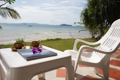 a table with a laptop on it on the beach at Koh Kwang Seaview in Klong Muang Beach