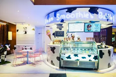 a store with a counter with cows on it at Holiday Inn Resort Phuket Surin Beach by IHG in Surin Beach