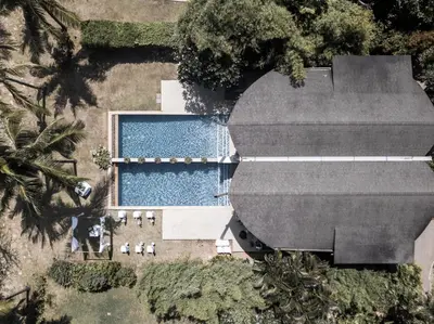 an overhead view of a swimming pool next to a house at Barcelo Coconut Island, Phuket in Phuket Town