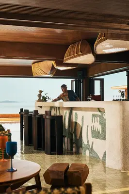 a man standing at a counter in a restaurant at Barcelo Coconut Island, Phuket in Phuket Town