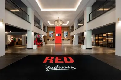a lobby with a red ribbon sign on the floor of a building at Radisson RED Phuket Patong Beach in Patong Beach