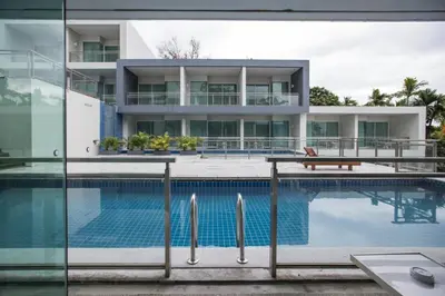 an external view of a house with a swimming pool at Sugar Palm Grand Hillside - SHA Plus in Kata Beach