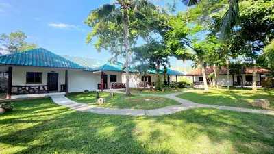 a house with a green yard with a pathway at Mild Garden View Resort in Ao Nang Beach