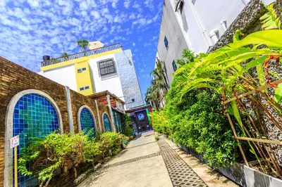a street in a city with buildings and plants at 7Q Patong Beach Hotel in Patong Beach