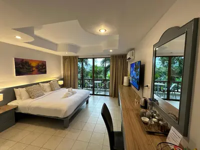 a bedroom with a bed and a large window at Sea Hills Resort in Patong Beach