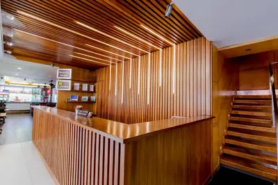 a lobby with a bar with wooden walls and stairs at Aspery Hotel in Patong Beach
