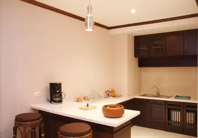 a kitchen with a sink and a counter top at Rayaburi Hotel, Patong in Patong Beach