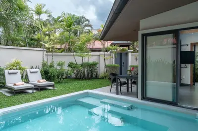 a swimming pool in the backyard of a house at Dewa Phuket Resort & Villas, Nai Yang Beach in Nai Yang Beach