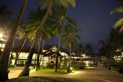 a group of palm trees in front of a building at Dusit Thani Laguna Phuket in Bang Tao Beach