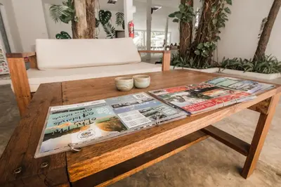 a wooden coffee table with magazines on top of it at Whalecome Aonang Resort-SHA Extra Plus in Ao Nang Beach