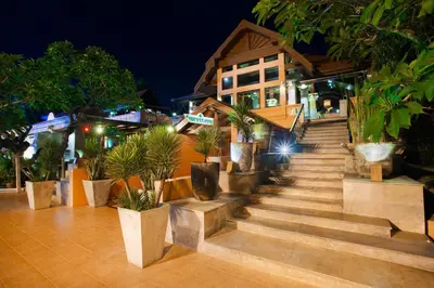 a set of stairs with potted plants in front of a building at Seaview Patong Hotel - SHA Plus in Patong Beach