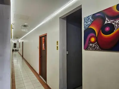 a hallway with a painting on the wall at The Album Loft in Patong Beach