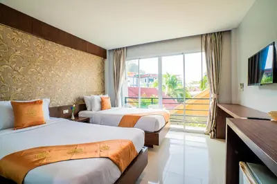 a hotel room with two beds and a balcony at Phi Phi Anita Resort in Phi Phi Don