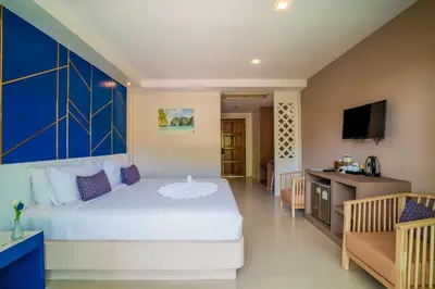 a bedroom with a large bed and a television at Phi Phi Anita Resort in Phi Phi Don