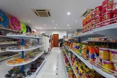 a store aisle with shelves of food and snacks at Baumancasa Beach Resort in Karon Beach