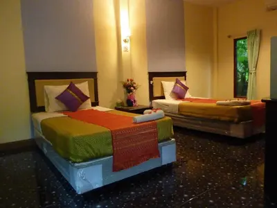 two beds in a hotel room at Aonang Green Park Bungalow in Ao Nang Beach