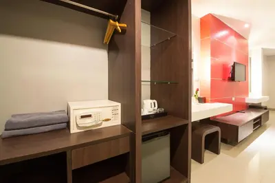 a small bathroom with a microwave and a sink at Alfresco Phuket Hotel in Patong Beach