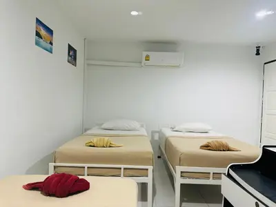 a room with two beds and a piano at Bang sit Guest House in Phi Phi Don