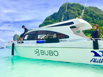 two people on a boat in the water at J Mansion in Ao Nang Beach