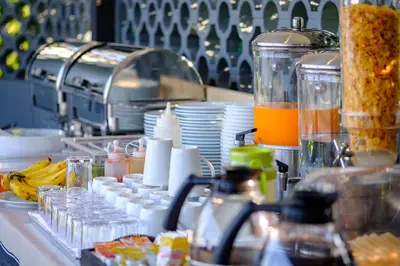 a kitchen counter with a bunch of food and drinks at Kamala Resotel, SHA Extra Plus in Kamala Beach
