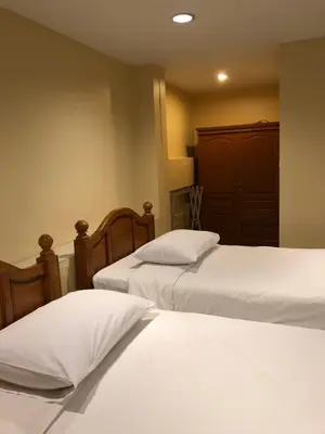 a bedroom with two beds with white sheets at Naithon Beach Residence in Nai Thon Beach