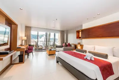 a hotel room with a bed and a desk at ASHLEE Hub Hotel Patong in Patong Beach