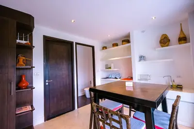 a dining room with a wooden table and chairs at Bungalow VILLA Rumba in Ko Yao Noi