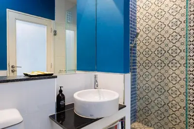 a bathroom with a white sink and a mirror at Signature Phuket Resort in Chalong