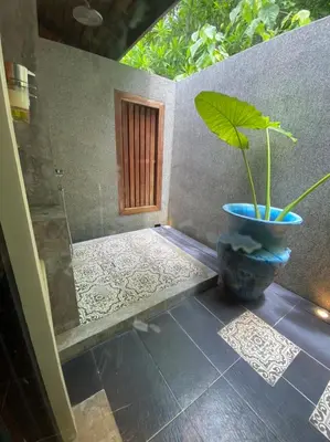 a plant in a blue pot next to a door at Bungalow VILLA Cha Cha in Ko Yao Noi