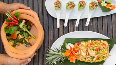 a table topped with plates of food and forks at Jivana Beach Villas in Natai Beach