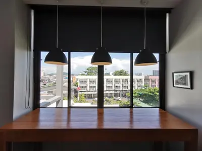 a dining room with a table and a large window at The Besavana Phuket - SHA Extra Plus in Phuket Town