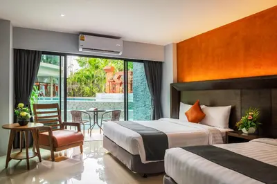 a hotel room with two beds and a table and chairs at Areca Resort and Spa in Kathu